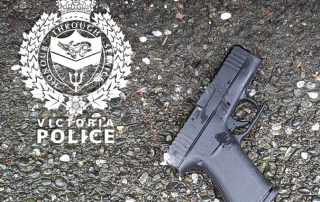 A loaded handgun lays on the pavement where it was recovered by officers